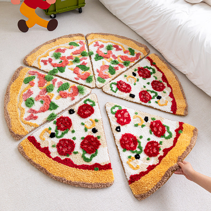 Seven plush pizza-slice rugs in a circle on a light floor, cream interiors with yellow crusts and red and g...