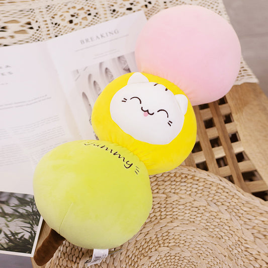 Three connected round plush cushions (light green, yellow with embroidered white cat face, pink) on brown s...