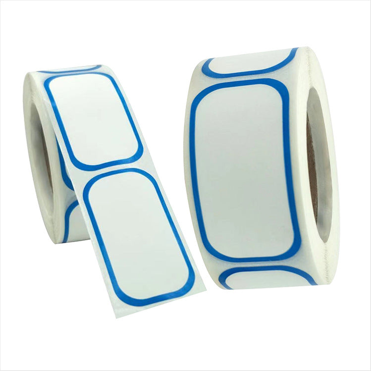 Two rolls of white rectangular labels with rounded corners and blue borders, one partially unrolled.