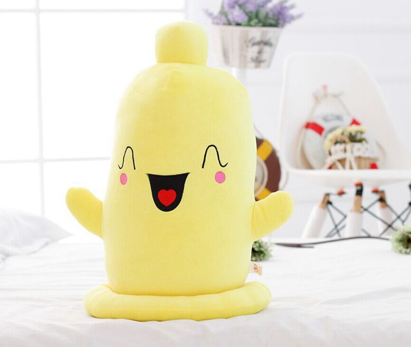 One yellow plush toy with a smiling embroidered face, pink cheeks, red heart tongue, stubby arms, round base.