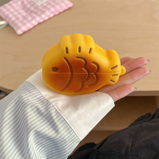 Taiyaki fish AirPods case held in an open hand