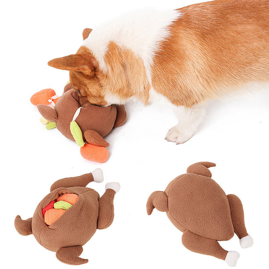 Brown-and-white corgi sniffing one of three brown plush chicken-shaped toys with orange and green felt