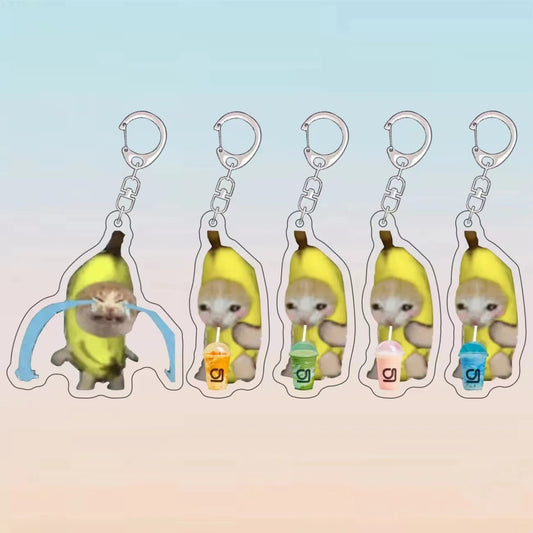 Five acrylic banana cat meme keychains, one crying and four holding different coloured drinks