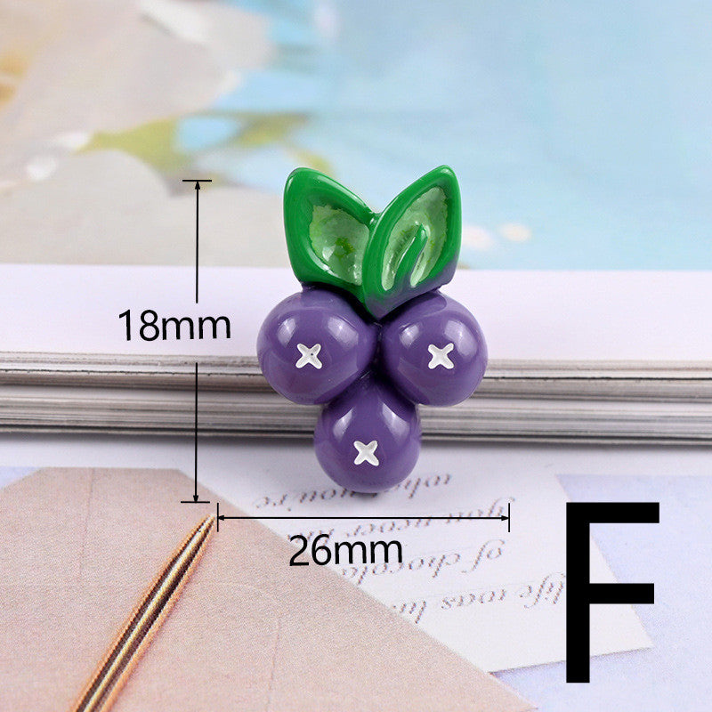 Single glossy purple three-berry cabochon with two green leaves and white 'X' centers, 18×26mm.