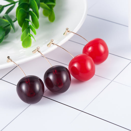Red and dark cherry stud earrings with a shiny finish, featuring gold-tone hooks against a white background.