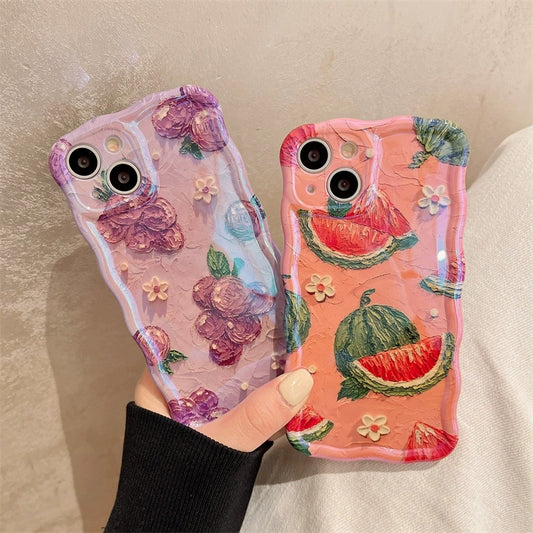 Two textured phone cases: lavender with raised roses and tiny white flowers; coral with watermelon slices.