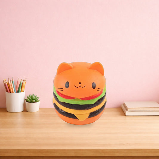 Cat face burger squishy sitting on a light oak desk beside pencils