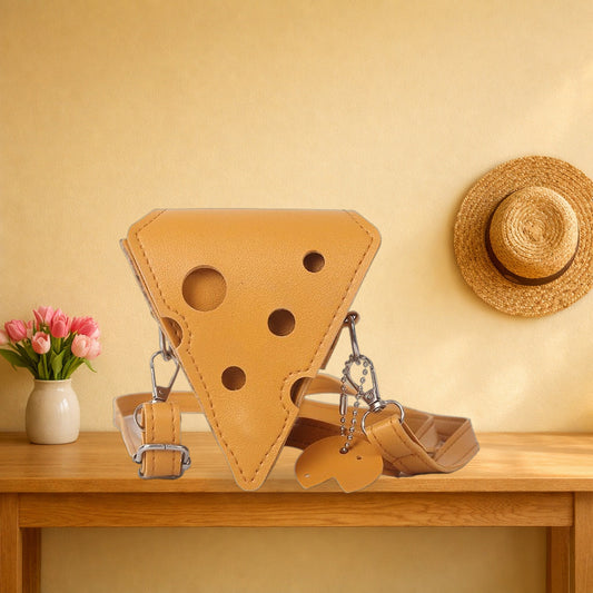 Triangle cheese crossbody bag with its strap on an oak hall table