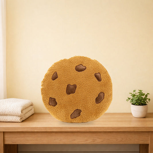 Chocolate chip cookie plush cushion standing on a light oak bench