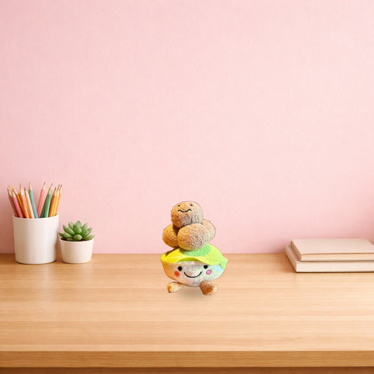 Beef ball bowl plush keychain on a light oak desk