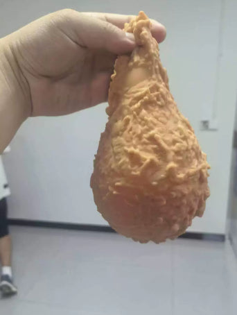 Fried chicken drumstick squishy in a hand