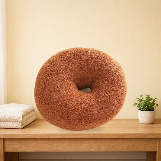 Brown boucle donut cushion on a light oak bench