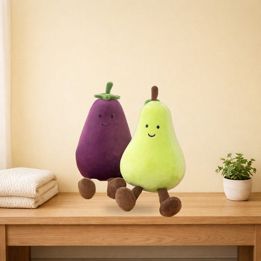 Eggplant and pear fruit plush toys sitting together on a light oak bench
