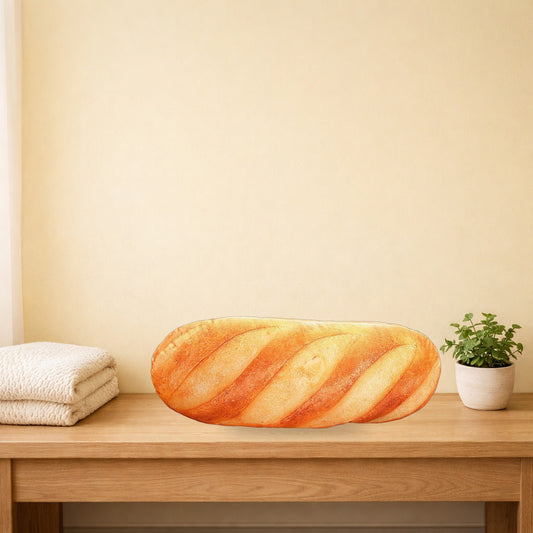 French bread plush pillow lying on a light oak console table