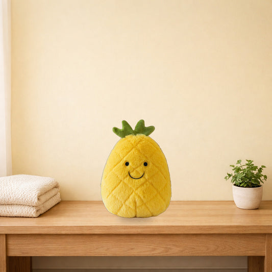 Fluffy pineapple plush with a smiley face sitting on a light oak bench