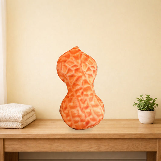 Giant peanut plush pillow on a light oak bench