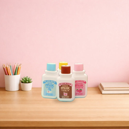 Milk bottle correction tapes standing on a light oak desk
