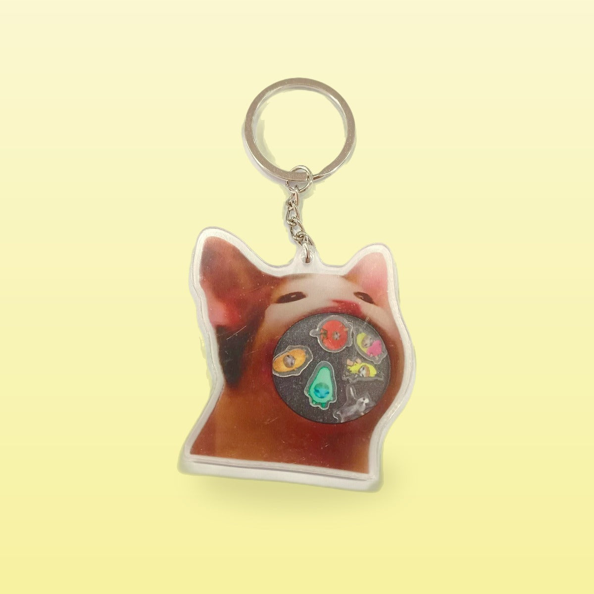 Rock music cat acrylic keychain with a cat face and a metal ring, on a butter yellow background