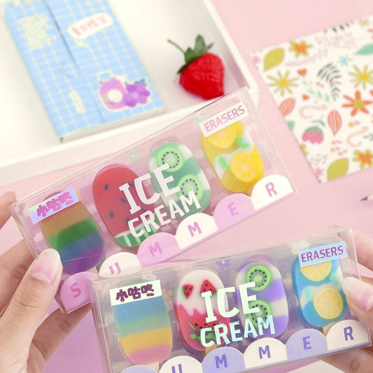 Hands holding a boxed set of four ice cream shaped erasers