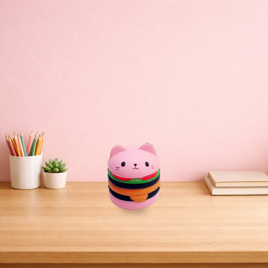 Pink cat burger squishy toy on a light oak study desk