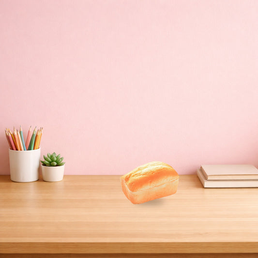 Split top loaf bread squishy on a light oak study desk