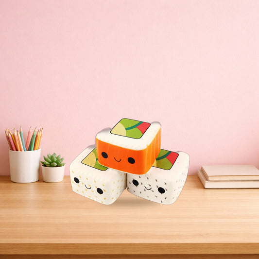 Three maki roll squishy toys stacked on a light oak desk