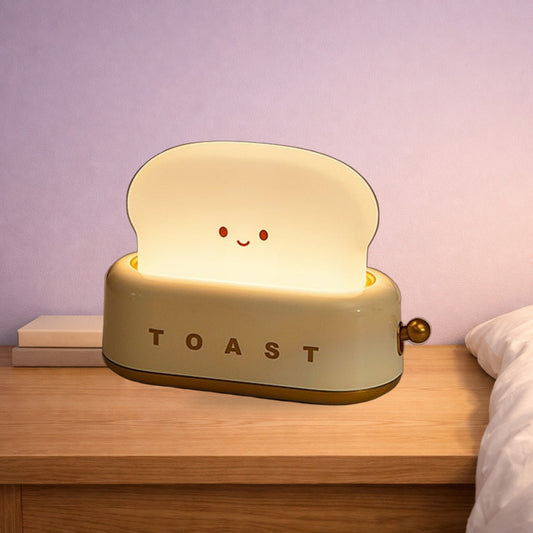 Green toaster night light glowing on an oak bedside table