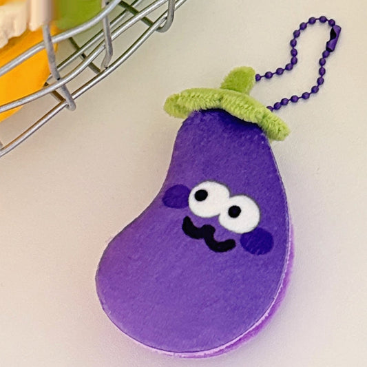Eggplant plush keychain with a purple bead chain and a cheeky smile