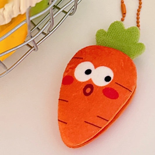 One orange plush carrot keychain with green felt top, white eyes, red cheeks, surprised mouth, orange chain.