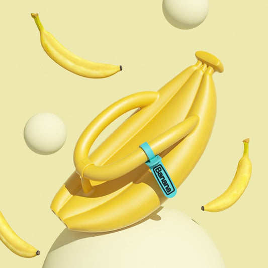 Yellow banana flip flop on a pastel yellow background with floating bananas