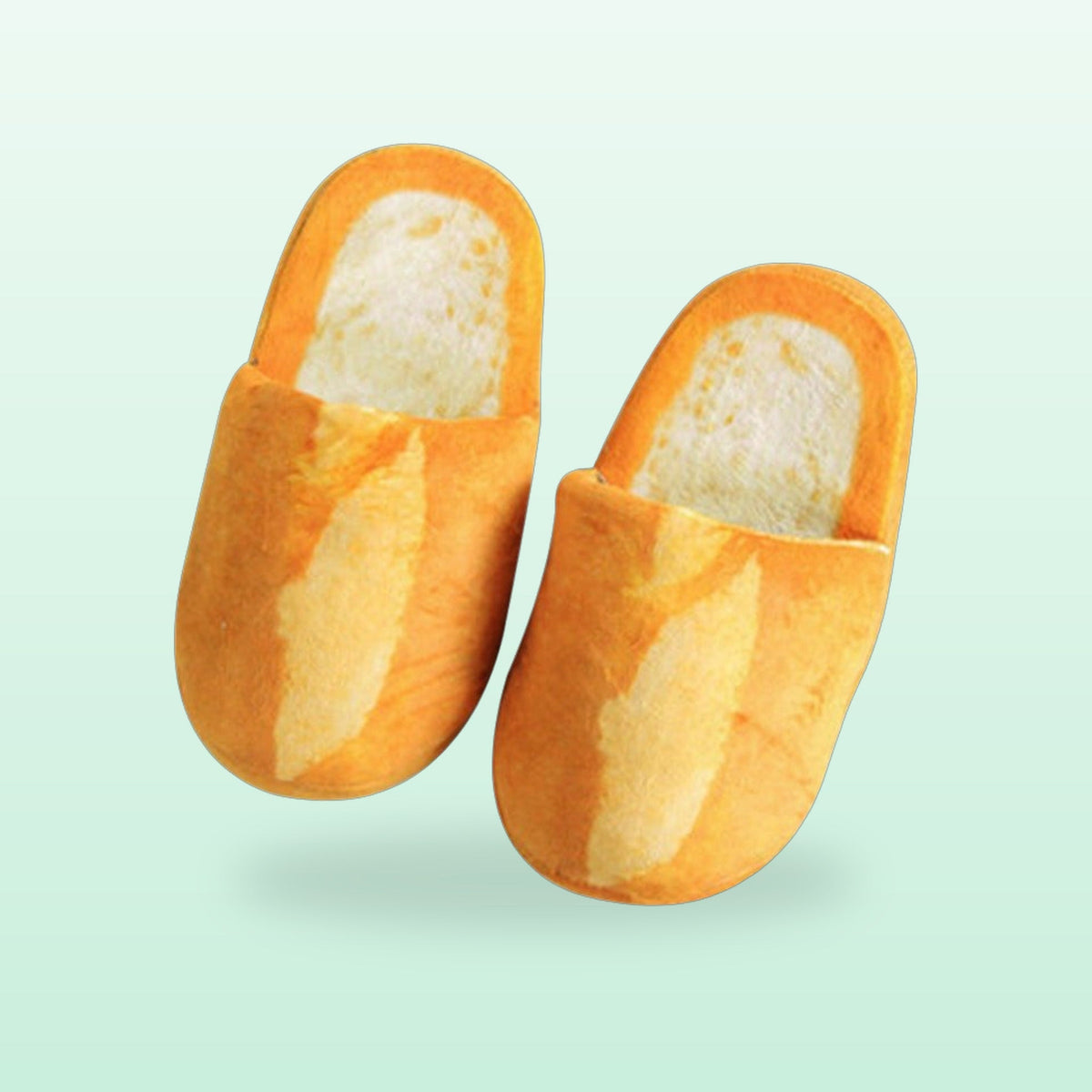 Baguette bread plush slippers, a golden crust pair with pale crumb insoles, on a mint background