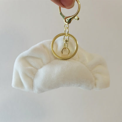 Dumpling plush keychain with a gold clasp