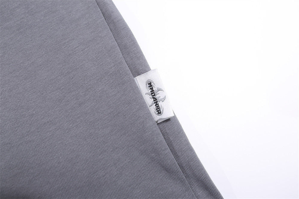 Grey T-shirt featuring a BBQ food print and a label detail on the sleeve.