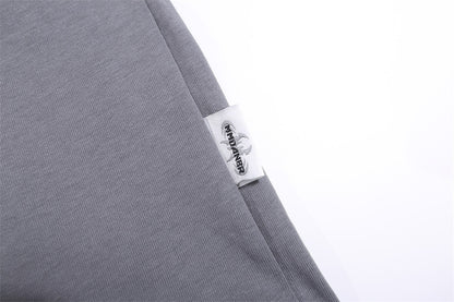 Grey T-shirt featuring a BBQ food print and a label detail on the sleeve.