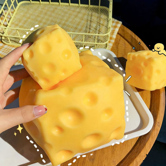 Large and small cheese block squishies on a tray