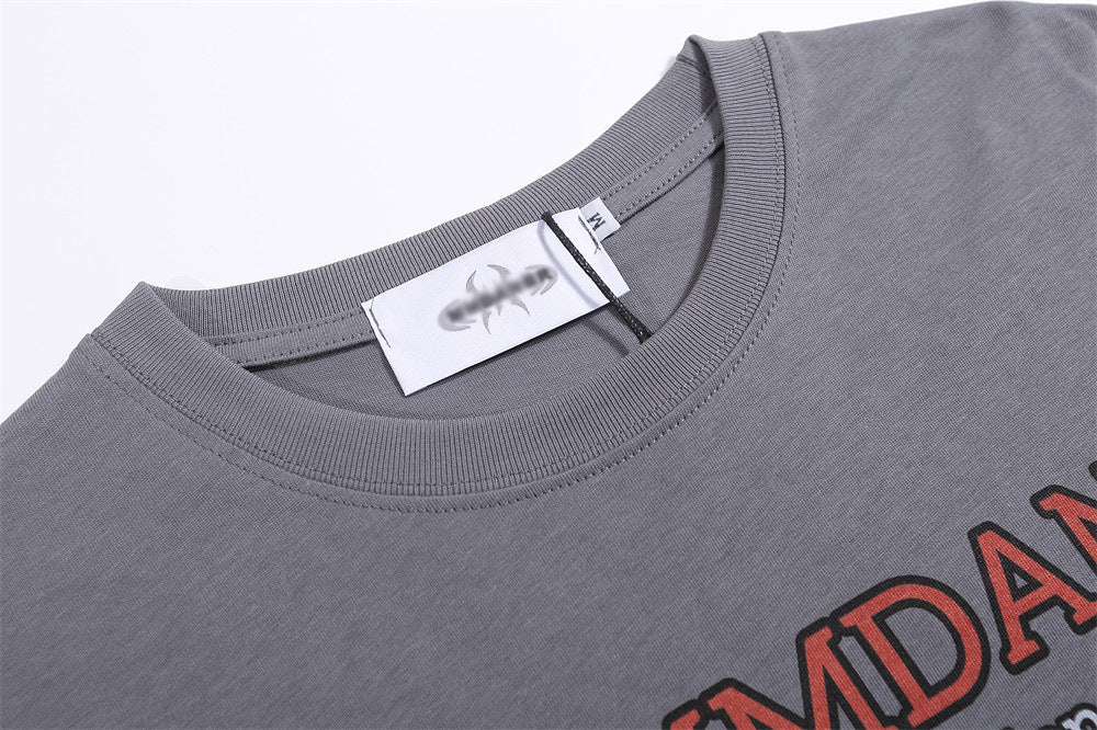 Grey T-shirt featuring a BBQ food print with bold red lettering, round neckline, and short sleeves.