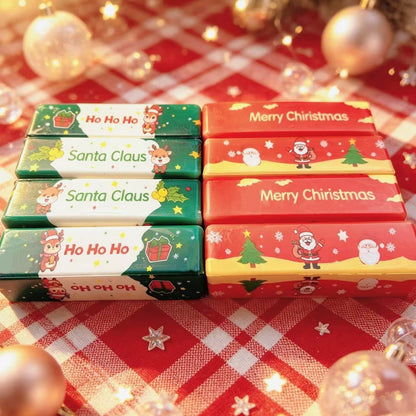 Red and green Christmas butter stick squishies on a tartan cloth