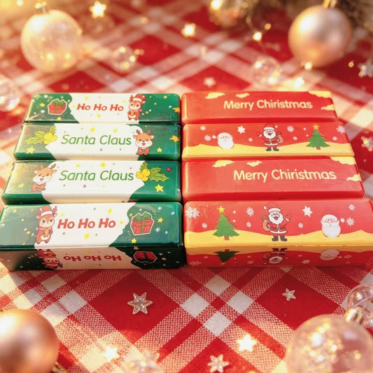 Red and green Christmas butter stick squishies on a tartan cloth
