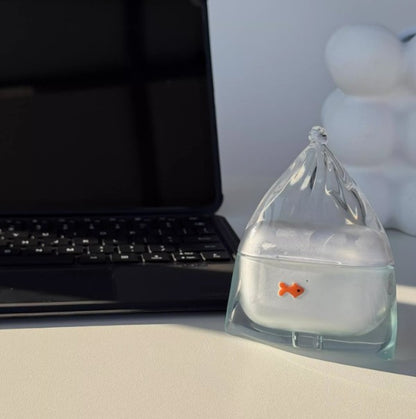 Lake blue goldfish in a bag AirPods case on a desk