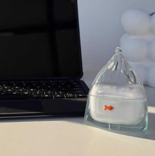 Lake blue goldfish in a bag AirPods case on a desk