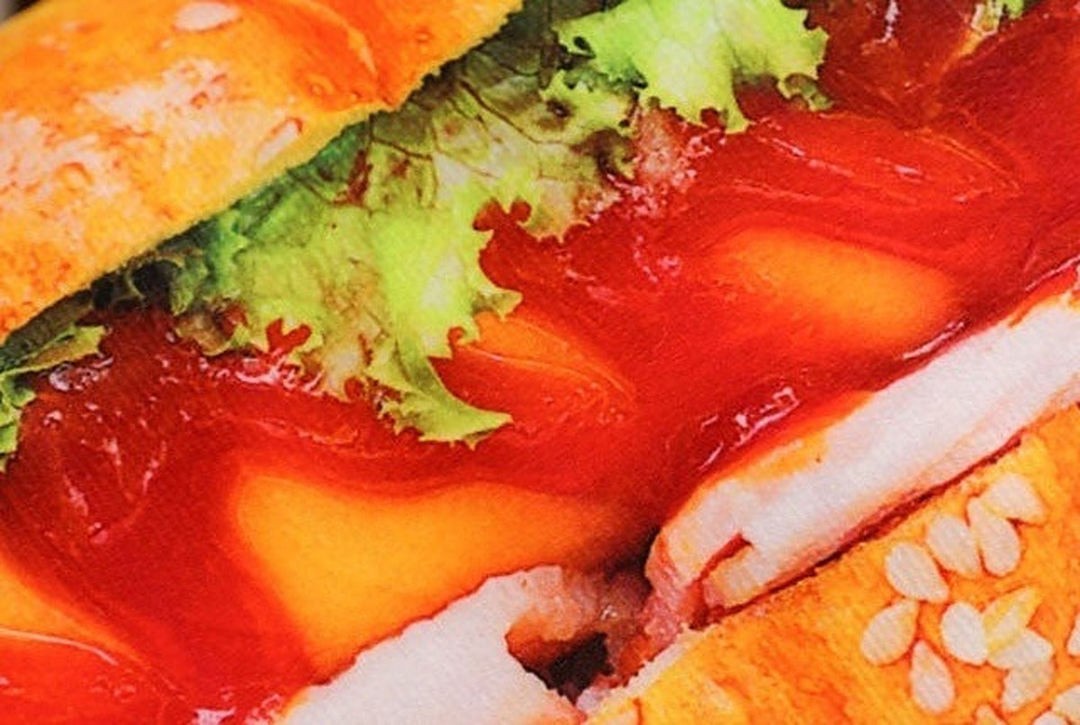 Close up of the hot dog pillow print with lettuce, ketchup, cheese and sesame seeds