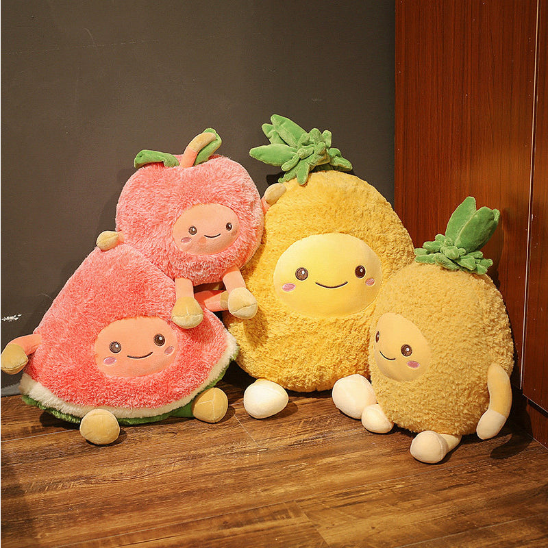 Four plush fruit toys: two pink round/wedge ones and two yellow pineapple plushes with green crowns.