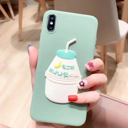 Mint-green iPhone case with 3D white-teal milk bottle, straw, banana icon and Korean text, held by hand.