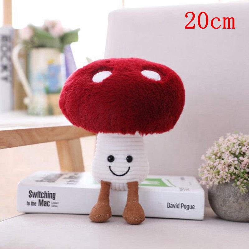One plush mushroom with red cap showing two white spots, ribbed white stem, embroidered smile and brown legs.