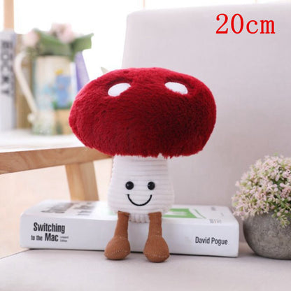 One plush mushroom with red cap showing two white spots, ribbed white stem, embroidered smile and brown legs.