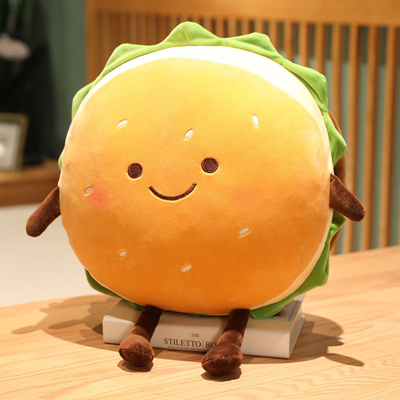 1 round orange hamburger plush cushion with smiling embroidered face, green lettuce trim and brown arms/legs.