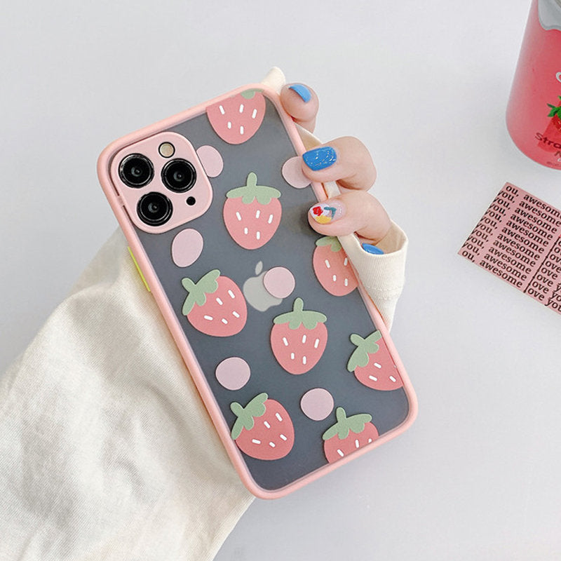 Clear iPhone case featuring a grey background adorned with pink strawberries and green accents, held in a hand.