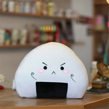 One white triangular rice ball pillow with black nori bottom, angry face and pink cheeks.