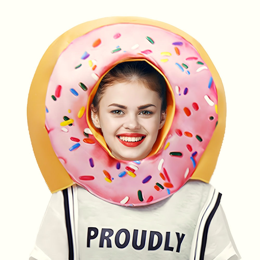 Pink sprinkle donut costume head piece worn by a smiling woman