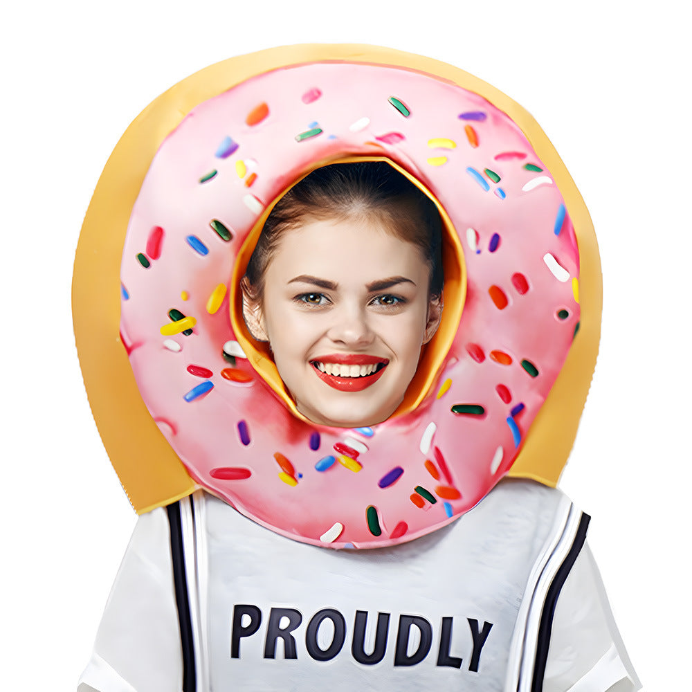 Pink sprinkle donut costume head piece worn by a smiling woman